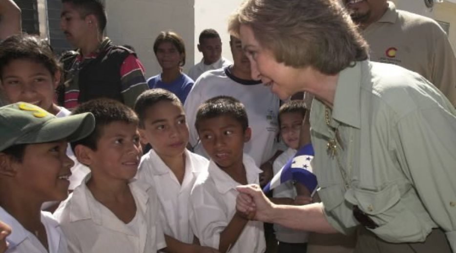 S. M. la Reina saluda a un grupo de niños durante la visita